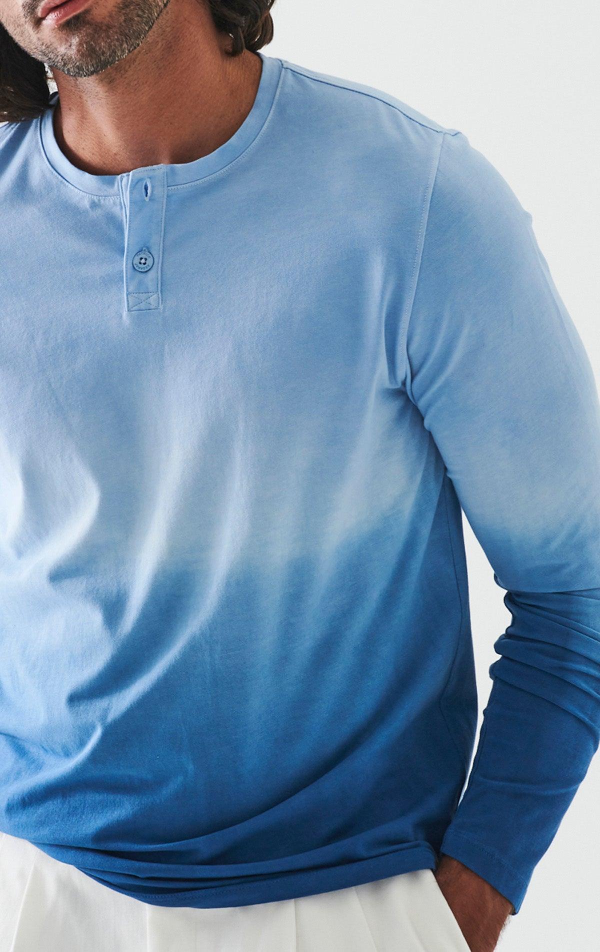 The ultimate in comfort and softness, this long sleeve cotton henly model sports a fine contemporary style. The soft blue combined with darker blues are washed for a soft, cool look. Soft pima cotton. Designed by Assaraf Italy. Button closure henly type collar. Open sleeves and bottom. Modern fit, perfect for a slim to medium build.